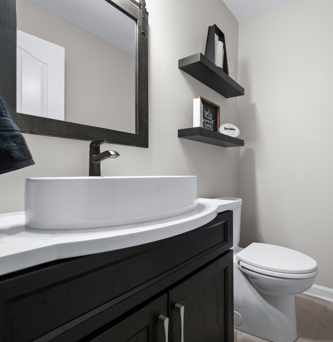 Powder Room - after: Medallion Cabinetry Wallace door style in Oak painted Carriage Black