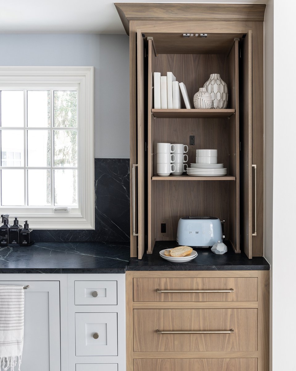 Grain-matched walnut towers flank the kitchen sink