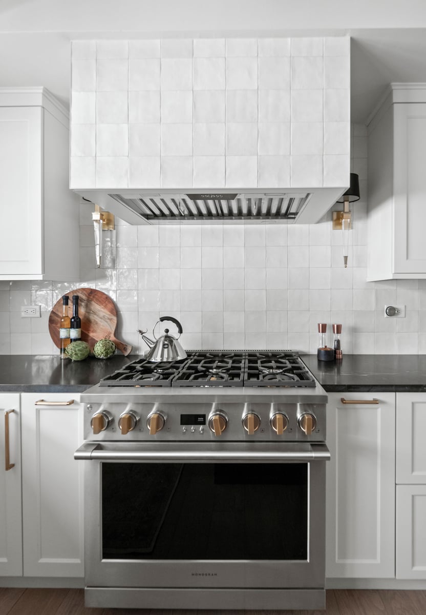 Nero Mist Honed granite countertops on perimeter, Flash Series Arizona Tile on full-height backsplash and hood