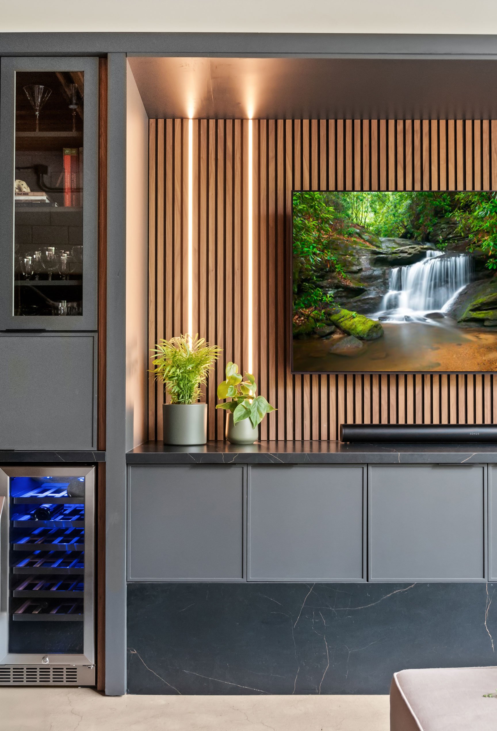 Contemporary loft entertainment area featuring natural walnut and black-painted Inspira Cabinetry