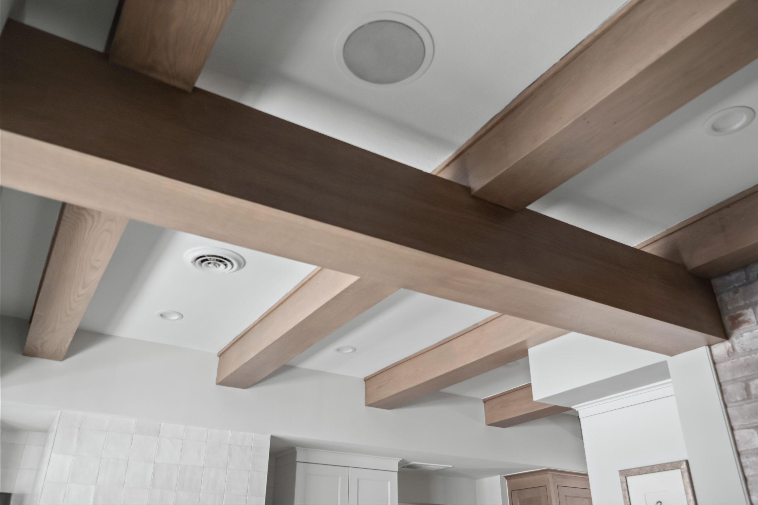 Existing beams wrapped in wood to compliment cabinetry in kitchen