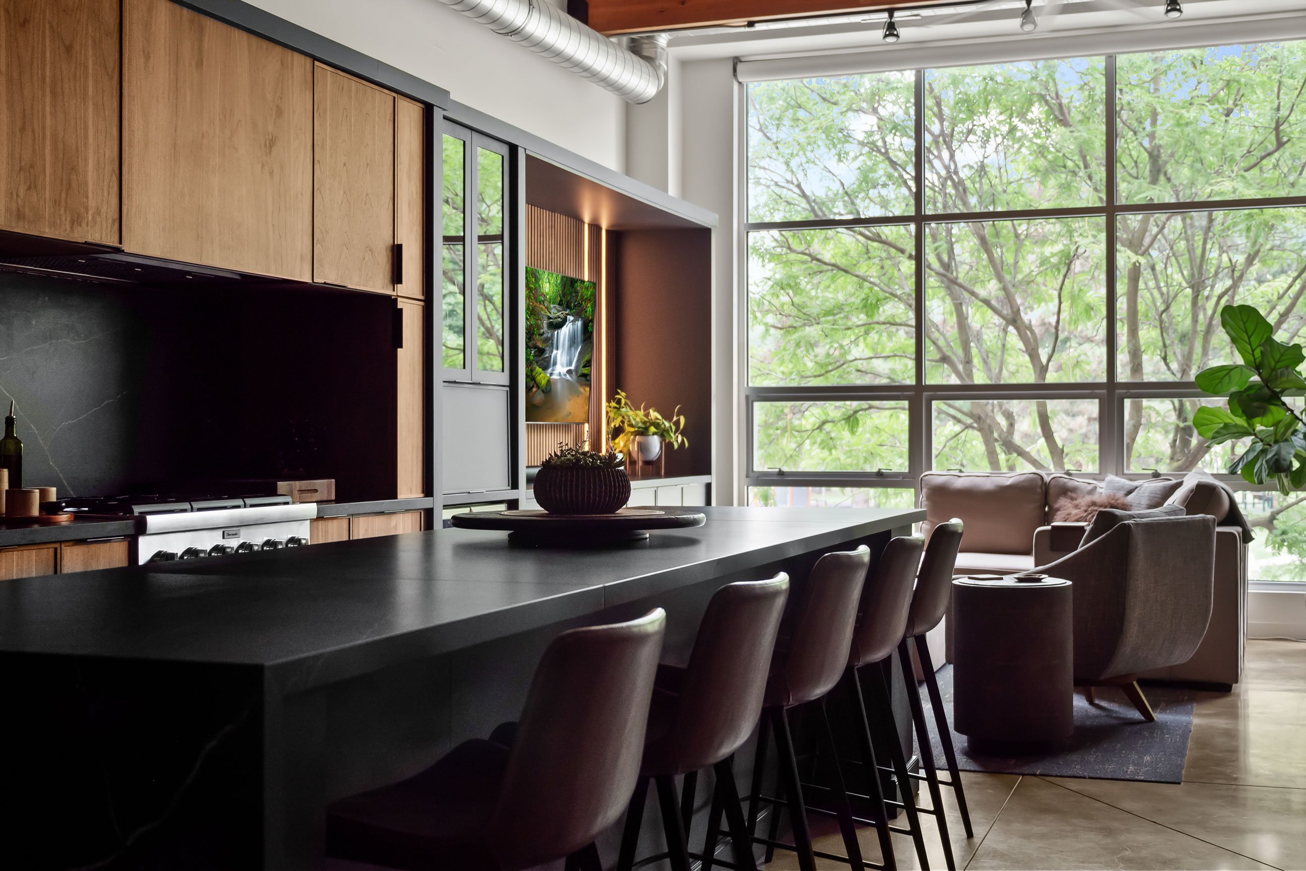 Contemporary loft kitchen featuring natural walnut and black-painted Inspira Cabinetry