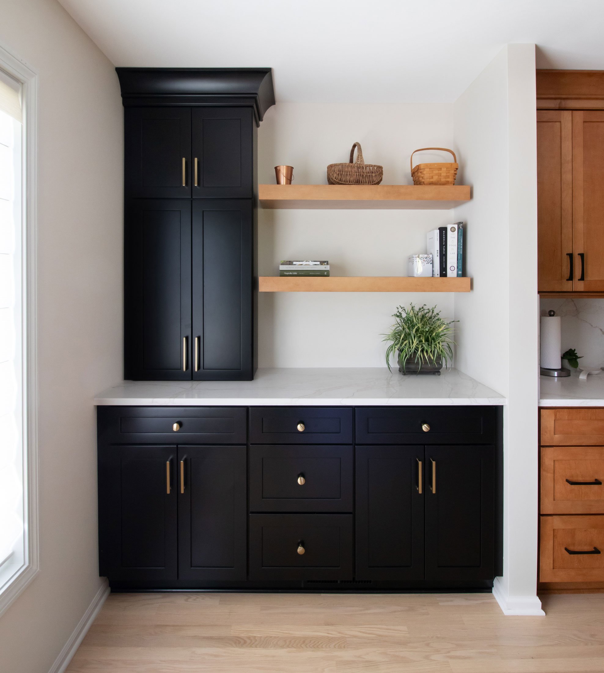 Black cabinetry accent section by dining area, open to the kitchen